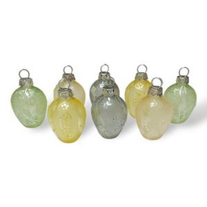 May include: A collection of eight glass Christmas ornaments in various pastel colors, including green, yellow, and silver. Each ornament has a loop for hanging and a delicate, embossed design. The ornaments are egg-shaped.