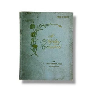 May include: A light blue vintage book with a gold embossed floral design on the cover. The text reads A McKinley Romance by Alice Danker Jones Canton, Ohio. The cover shows signs of wear and discoloration, with the price 50 cents printed.