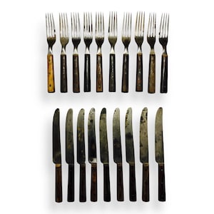 May include: A white ceramic mug with a black handle and the text "But First, Coffee" in a black, handwritten-style font. The mug is on a white surface.