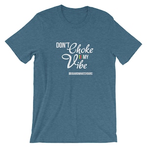 May include: A blue t-shirt with white text that reads "Don't Choke My Vibe" with a red, yellow, and green stripe under "My". The text "||GUARDWHATSYOURS" is below the main text.
