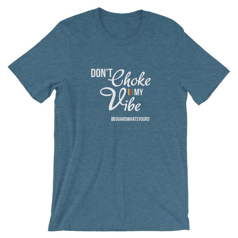 May include: A blue t-shirt with white text that reads "Don't Choke My Vibe" with a red, yellow, and green stripe under "My". The text "||GUARDWHATSYOURS" is below the main text.