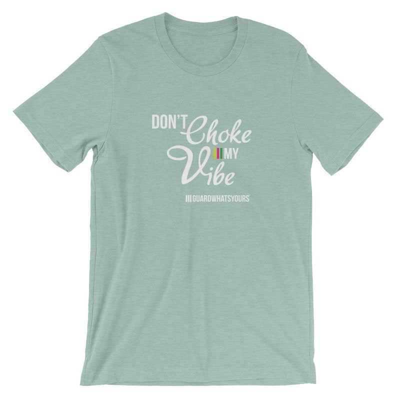 May include: A light blue t-shirt with the text "Don't Choke My Vibe" in white lettering. The text is in a cursive font and includes a small rainbow flag graphic. The text "III GUARDWHATSYOURS" is also included in white lettering.