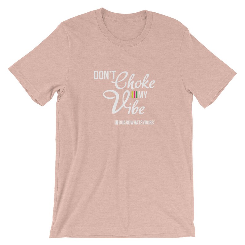 May include: A pink t-shirt with the text "Don't Choke My Vibe" in white with a small multi-colored flag graphic. The text "#GUARDWHATSYOURS" is below the main text.