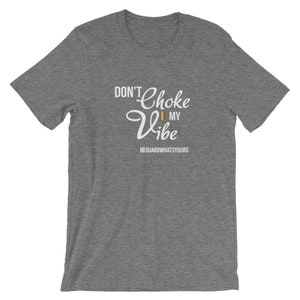 May include: Gray short-sleeved t-shirt with white text that reads "Don't Choke My Vibe" with a small flag graphic and the text "#GUARDWHATSYOURS" below.