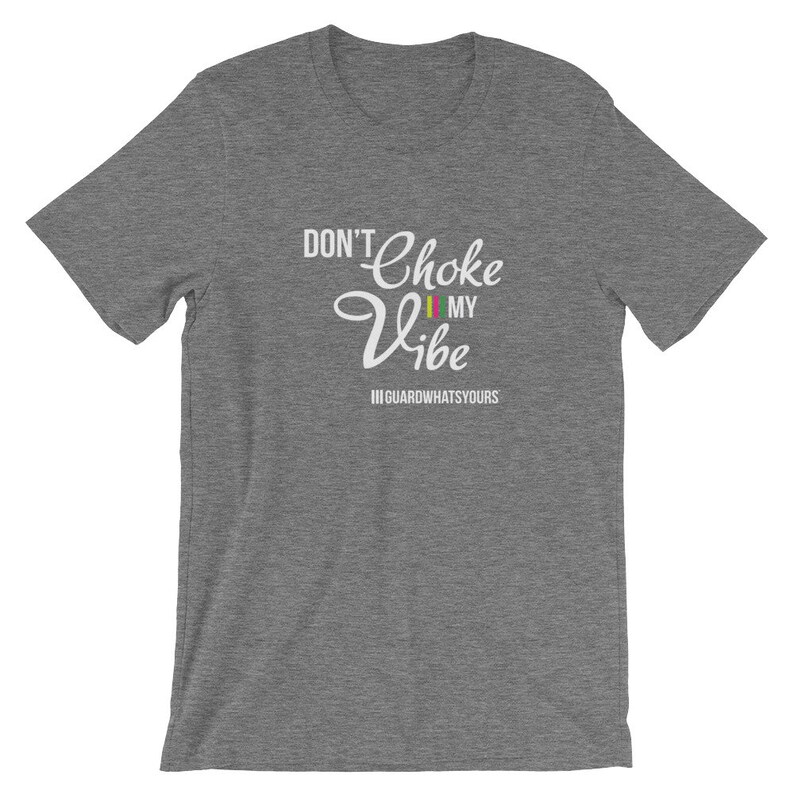 May include: Gray short-sleeved t-shirt with white text that reads "Don't Choke My Vibe" with a small flag graphic and the text "#GUARDWHATSYOURS" below.