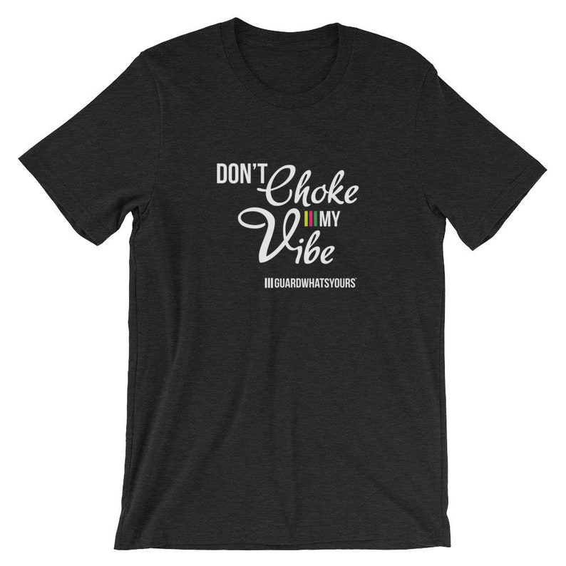 May include: A dark heather grey t-shirt with white text that reads "Don't Choke My Vibe" with a colorful stripe pattern and the text "IIGUARDWHATSYOURS" underneath.