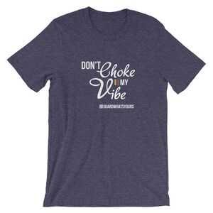 May include: A navy blue t-shirt with the text "Don't Choke My Vibe" in white with a colorful stripe design. The text "#GUARDWHATSYOURS" is also printed in white below the main text.