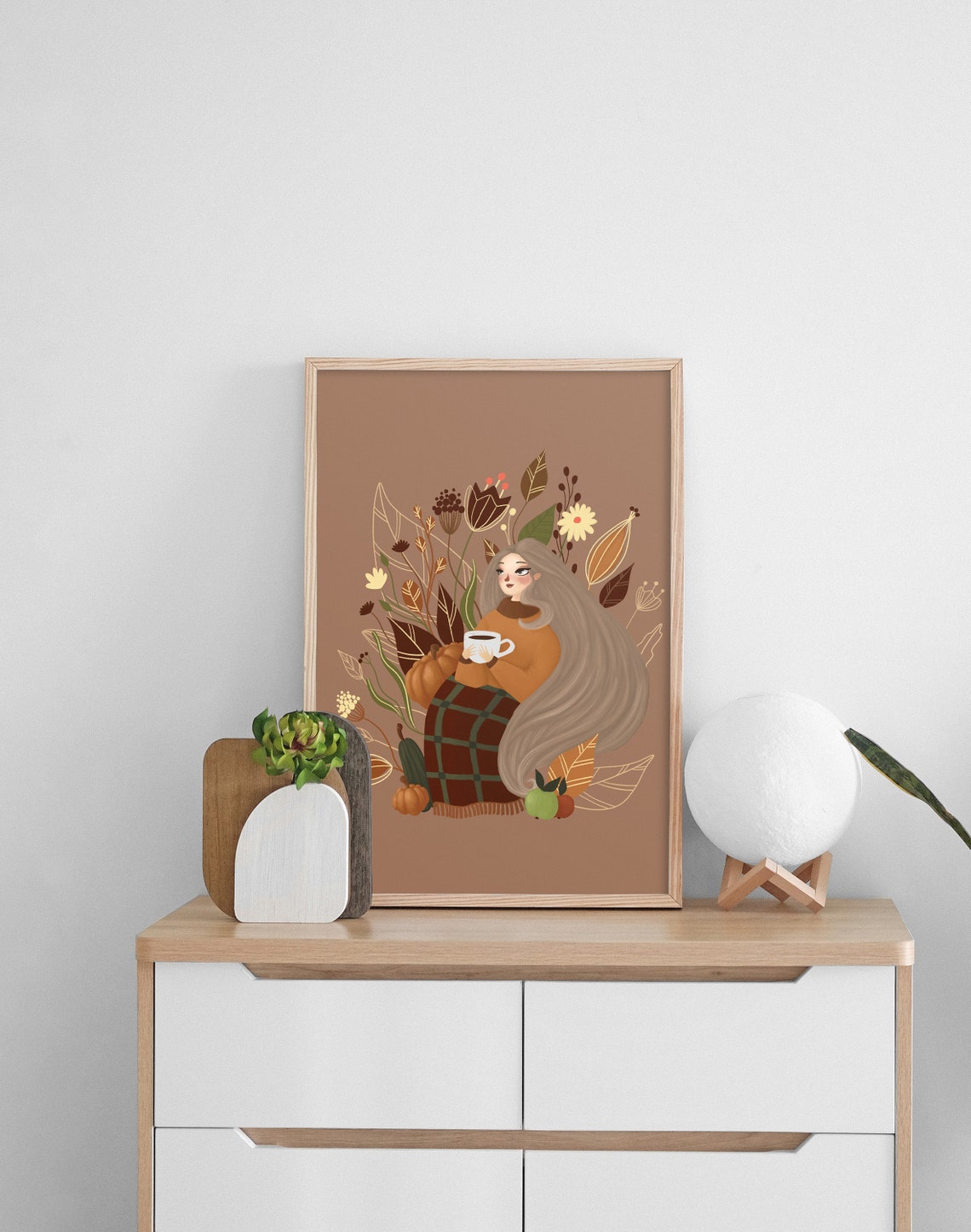 Fall wall art with a girl drinking coffee, tea, autumn leaves, flowers. Autumn wall decor is unique Thanksgiving decor and printable art.