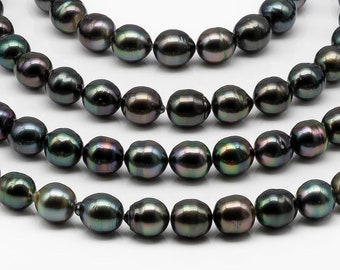 May include: Strands of dark gray pearls with iridescent hues. The pearls are strung on thin, clear cords, and are arranged in a layered pattern against a white background. The pearls have a smooth, round shape.
