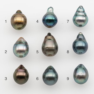 May include: Nine iridescent, teardrop-shaped pearls in various colors, including gold, teal, and gray, are displayed against a white background. Each pearl has a unique shape and luster, showcasing natural variations. These pearls are suitable for jewelry making.