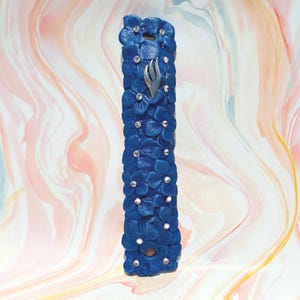Matte Blue Mezuzah Case with Silver Shin and Bejewelled Flowers.