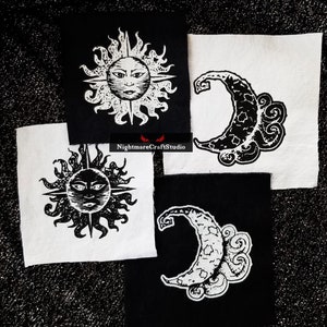 May include: Four iron-on patches featuring black and white illustrations of a sun and a crescent moon. The patches are on black and white fabric.