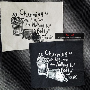 May include: Two black and white iron-on patches with the text "As Charming As We Are, We Are Nothing But Pretty Trash" and a drawing of two trash cans. The patches are on a white and black fabric background.