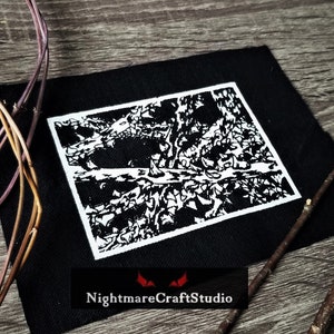 May include: Black and white embroidered patch featuring a detailed design of a tree with branches and leaves. The patch is on a black fabric background. The text "NightmareCraftStudio" is visible at the bottom of the image.