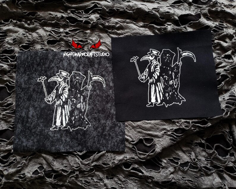 May include: Two black and white iron-on patches featuring a plague doctor holding a staff and a scythe. The patches are on a gray, textured fabric background. The text "NIGHTMARE CRAFTS STUDIO" is visible on one of the patches.