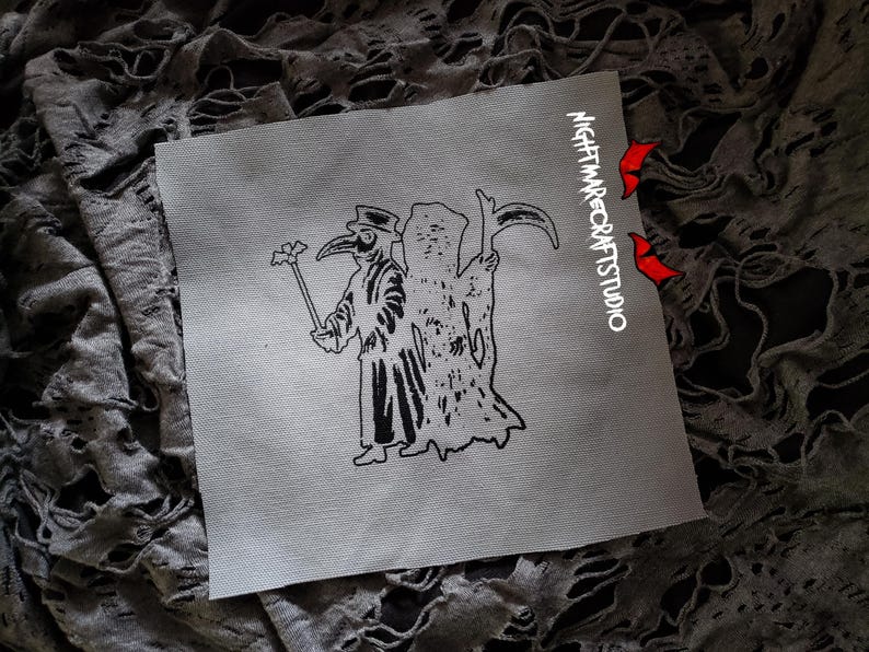 May include: Black and white embroidered patch featuring a plague doctor holding a staff with a flower on top, and a skeletal figure behind them. The patch has the text "NIGHTMARECRAFTSSTUDIO" in white on a black background.