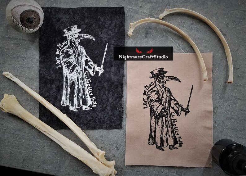 May include: Two black and white images of a plague doctor with a long beak mask and a hat. The text "Lost My Mind" and "Clinically Fine" is written on the images. The images are printed on fabric.