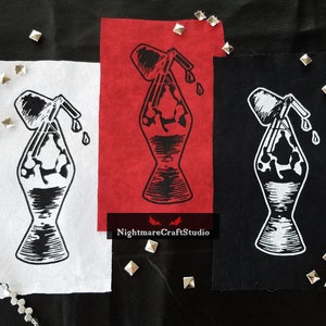 May include: Three iron-on patches featuring a black and white illustration of a lava lamp with a dripping spout. The patches are on white, red, and black fabric.