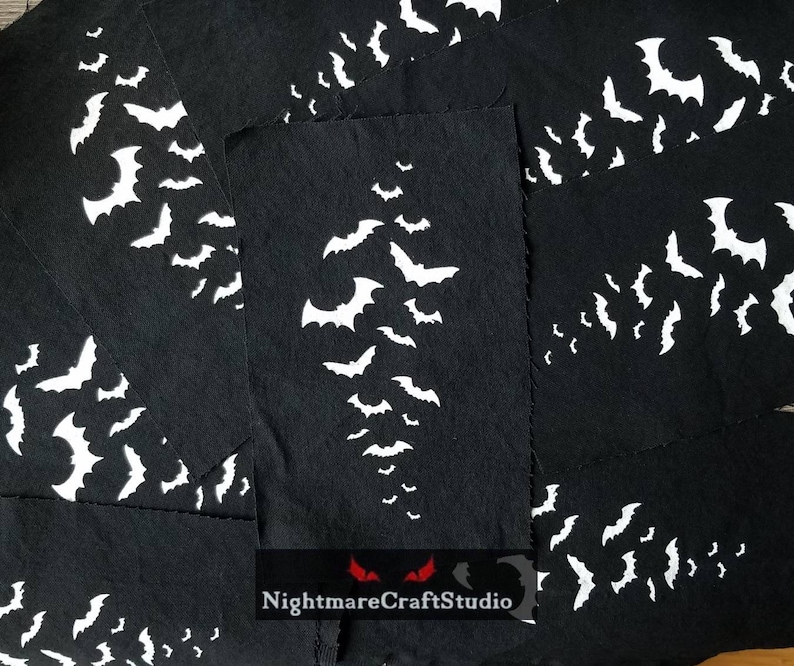May include: Multiple black fabric squares with white bat silhouettes printed on them. The fabric squares are stacked on top of each other. The text "NightmareCraftStudio" is printed on the bottom of the image.