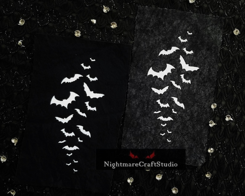 May include: Two black fabric panels with white bat silhouettes cut out. The bats are arranged in a vertical pattern, with the largest bat at the top and the smallest bats at the bottom. The fabric panels are textured and have a slightly distressed look. The text "NightmareCraftStudio" is printed in red at the bottom of the image.