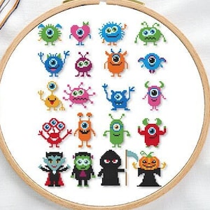May include: A cross-stitch pattern featuring 20 colourful cartoon monsters, including a vampire, a Frankenstein, a grim reaper, and a pumpkin. The monsters are stitched on white fabric and framed in a wooden hoop.
