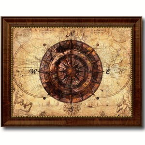 May include: A framed vintage-style compass with a brown and gold design. The compass is set against a background of a faded world map with the letters N, S, E, and W.
