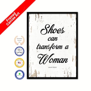 May include: A framed canvas print with a white background and black text that reads "Shoes can transform a Woman" with the name "manolo blahnik" underneath.