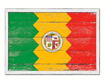 May include: A weathered wooden sign with a white frame, featuring the official seal of the City of Los Angeles. The seal is a circular design with a red and gold shield, a bear, and the words "City of Los Angeles Founded 1781". The sign is painted in the colors of the Los Angeles flag: green, yellow, and red.