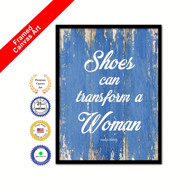 May include: Framed canvas art print with a blue woodgrain background and white text that reads "Shoes can transform a Woman" with the name "Manolo Blahnik" underneath.