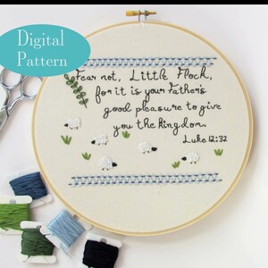 May include: Embroidered hoop art featuring the quote "Fear not, Little Flock, for it is your father's good pleasure to give you the kingdom. Luke 12:32". The hoop is surrounded by green and blue embroidery floss.