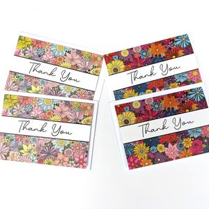 May include: A collection of floral "Thank You" cards. Each card features a vibrant floral design in shades of pink, yellow, orange, and blue. The words "Thank You" are printed in black script across a white band.