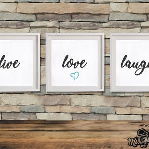 Può includere: Tre stampe incorniciate con le parole "live", "love" e "laugh" in corsivo nero. La parola "love" ha un cuore turchese. Le cornici sono bianche e lo sfondo è un muro di mattoni.