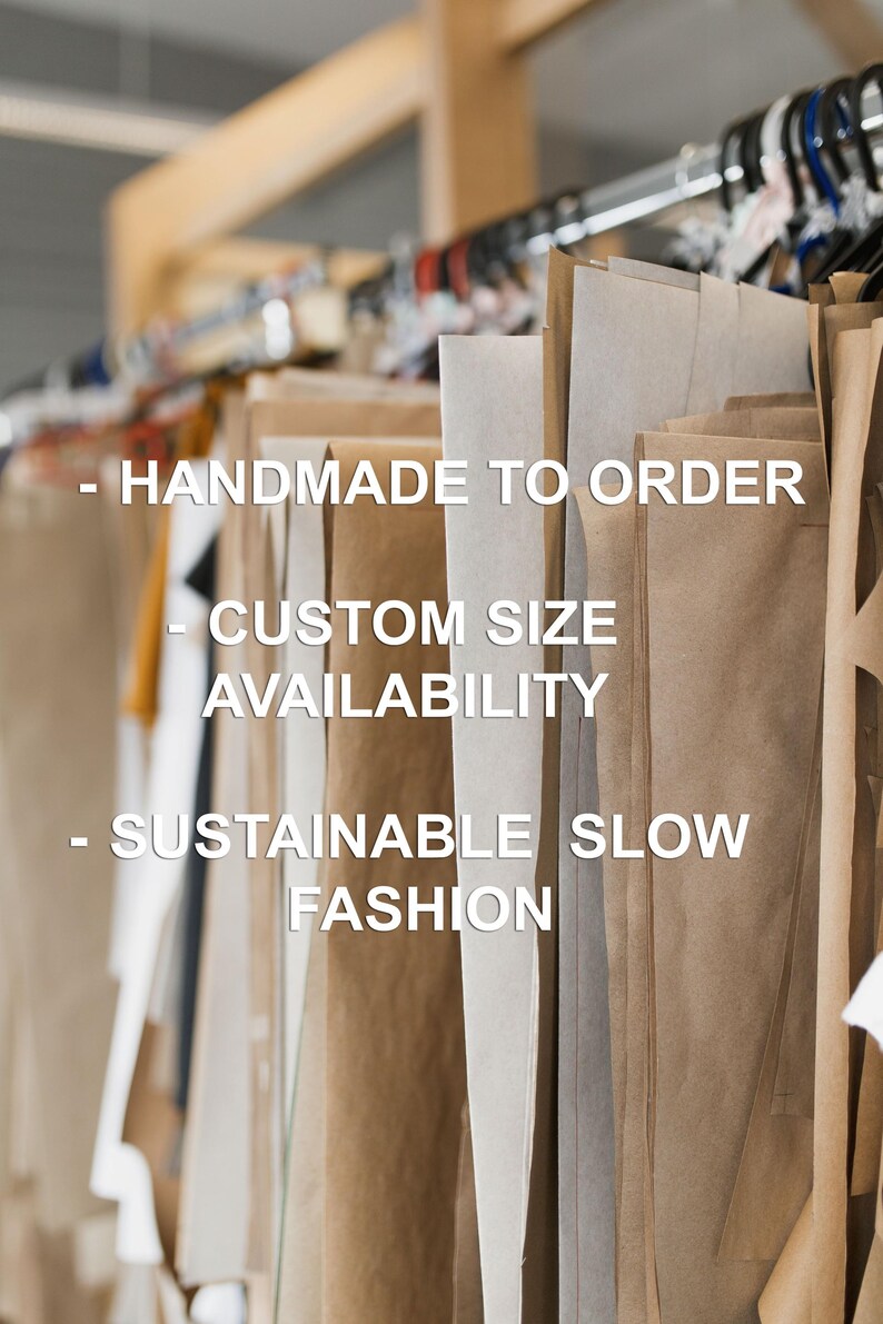 May include: Multiple large sheets of brown and white paper patterns hanging on a clothing rack. The text on the image reads: - HANDMADE TO ORDER - CUSTOM SIZE AVAILABILITY - SUSTAINABLE SLOW FASHION. The patterns are suspended from black hangers.