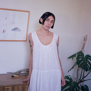 White linen sleeveless dress with ruffled hem