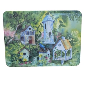 May include: Rectangular serving tray featuring a watercolor painting of birdhouses nestled in a lush garden. The birdhouses are painted in shades of white, blue, and brown, with a blue bird perched on one. The background is filled with green foliage and colorful flowers.