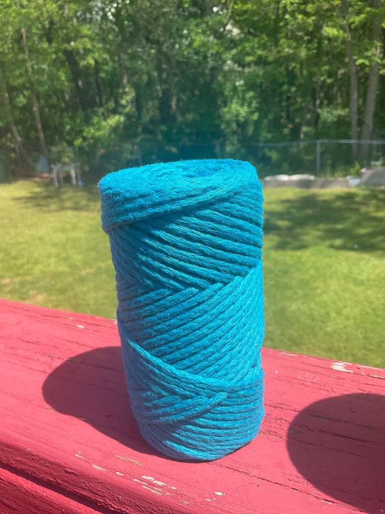 May include: A roll of teal blue cotton rope, perfect for crafting projects.