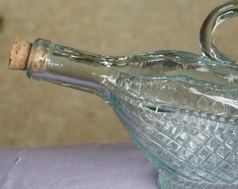 Spanish Glass Decanter, made in the shape of a Bottle in a Basket, with Handle. 11” Long.