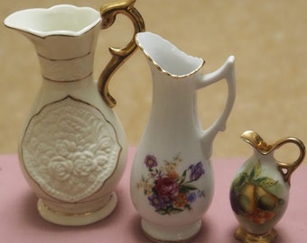 A Collection of three little  jugs 15cms tall and 13cms tall and 8cms tall. In very good condition.
