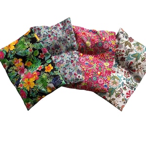 May include: A collection of colorful fabric pieces with floral patterns. The fabrics feature a variety of designs, including tropical flowers, small blossoms, and intricate botanical prints. The color palette includes vibrant hues of pink, yellow, blue, and green.