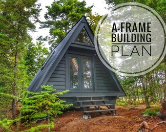 May include: A-frame cabin with a dark gray exterior and a wooden deck with steps. The cabin is surrounded by trees. The text "A-FRAME BUILDING PLAN" is superimposed on the image.