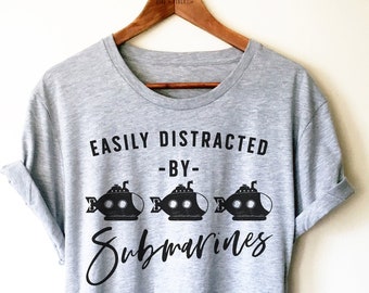 May include: Grey t-shirt with black text that reads "Easily Distracted - By - Submarines" and three black submarine illustrations.