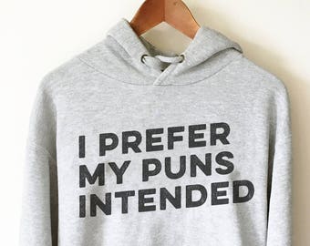 May include: A gray hooded sweatshirt with the text "I prefer my puns intended" printed in black.