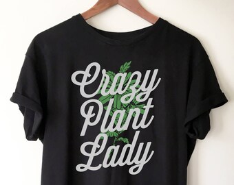 May include: Black t-shirt with white text that reads "Crazy Plant Lady" with a green plant graphic.