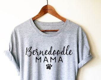 May include: Gray t-shirt with black text that reads "Bernedoodle Mama" and a black paw print.