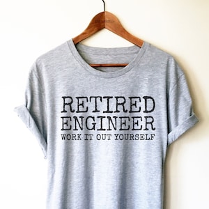 May include: A grey t-shirt with the text "Retired Engineer Work It Out Yourself" printed in black.