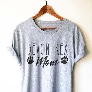 May include: Gray t-shirt with the text "Devon Rex Mom" and paw prints in black.