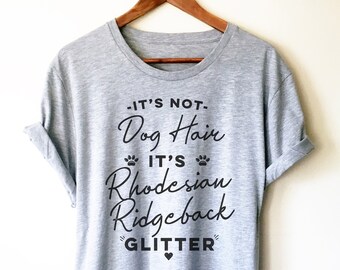 May include: A gray t-shirt with the text "It's not. Dog Hair. It's Rhodesian Ridgeback Glitter" printed on it.