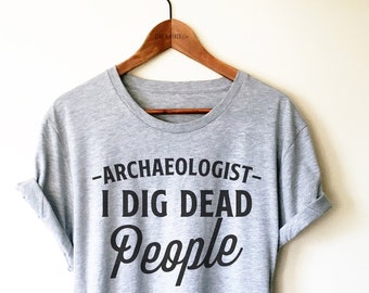May include: Gray t-shirt with black text that reads "Archaeologist - I Dig Dead People".