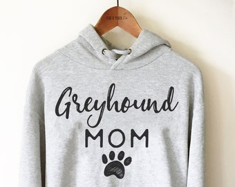 May include: Gray hooded sweatshirt with the text "Greyhound MOM" and a black paw print.