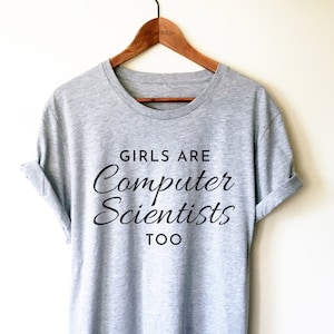 May include: Grey t-shirt with the text "Girls are Computer Scientists Too" printed in black.